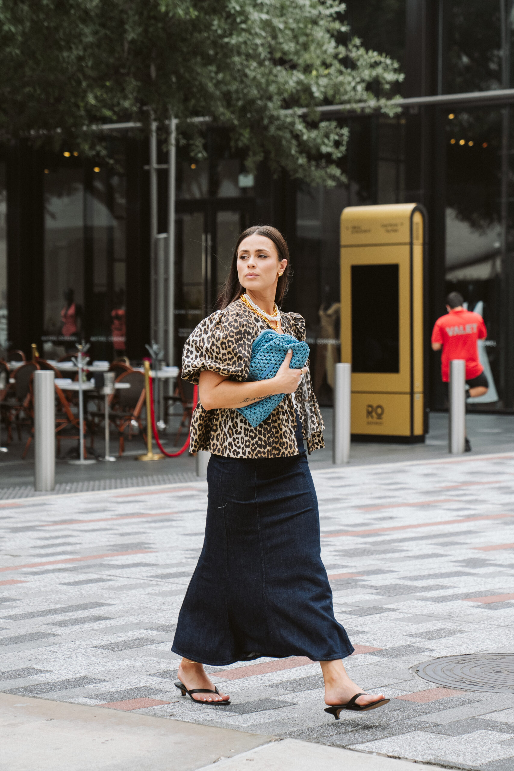 zara midi skirt styled with ganni leopard bubble top and a blue hand bag