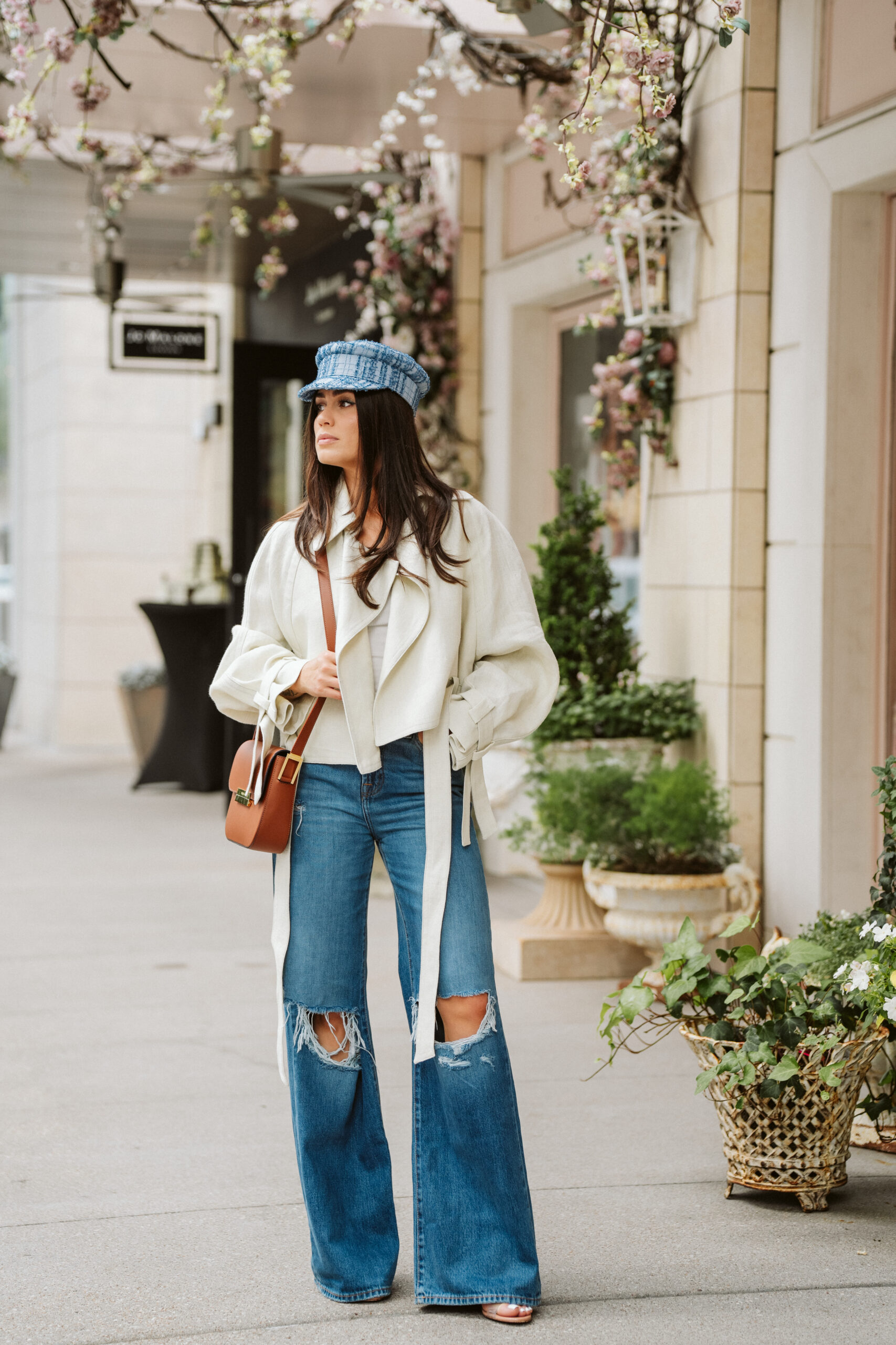 casual look with jeans, oversized cream cropped coat from mango, and a brown purse